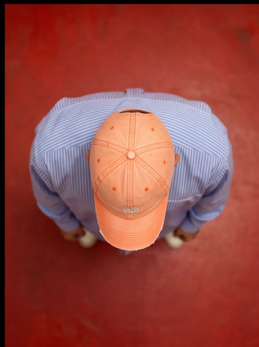 Overhead shot of BDJ in a peach cap and striped shirt