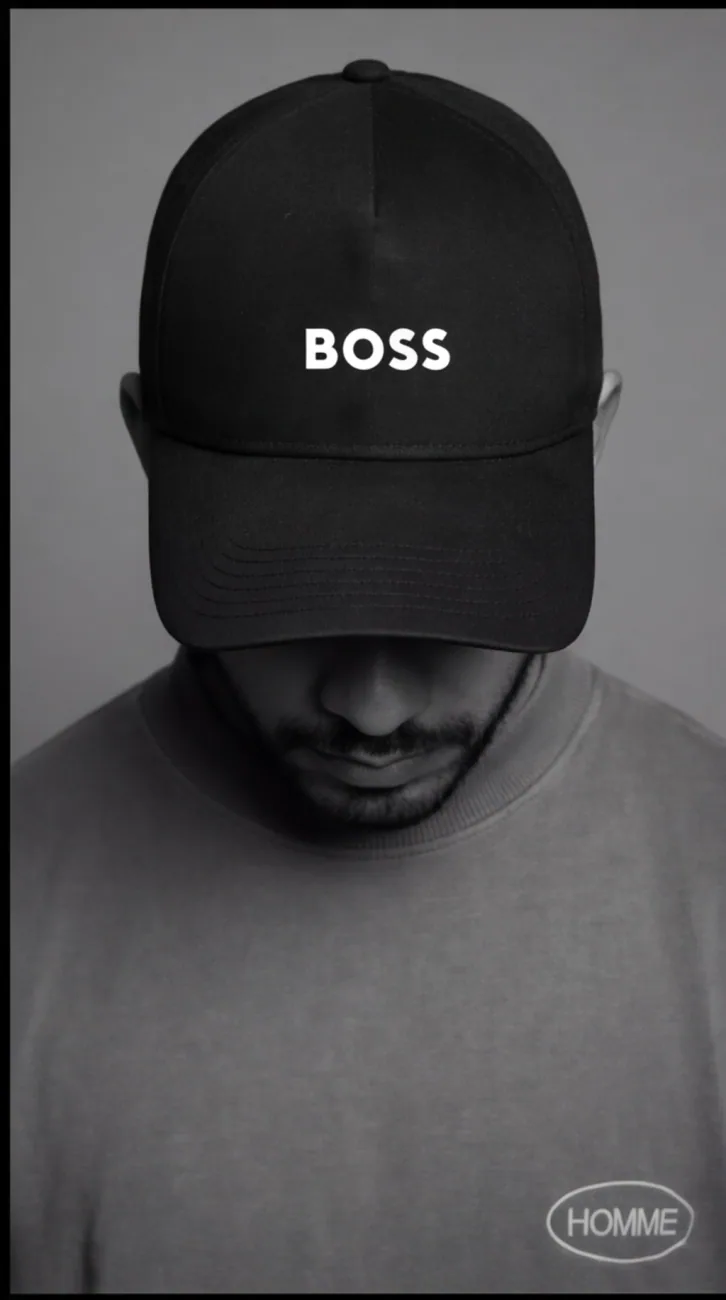 Black and white portrait of BDJ, cap low over his face