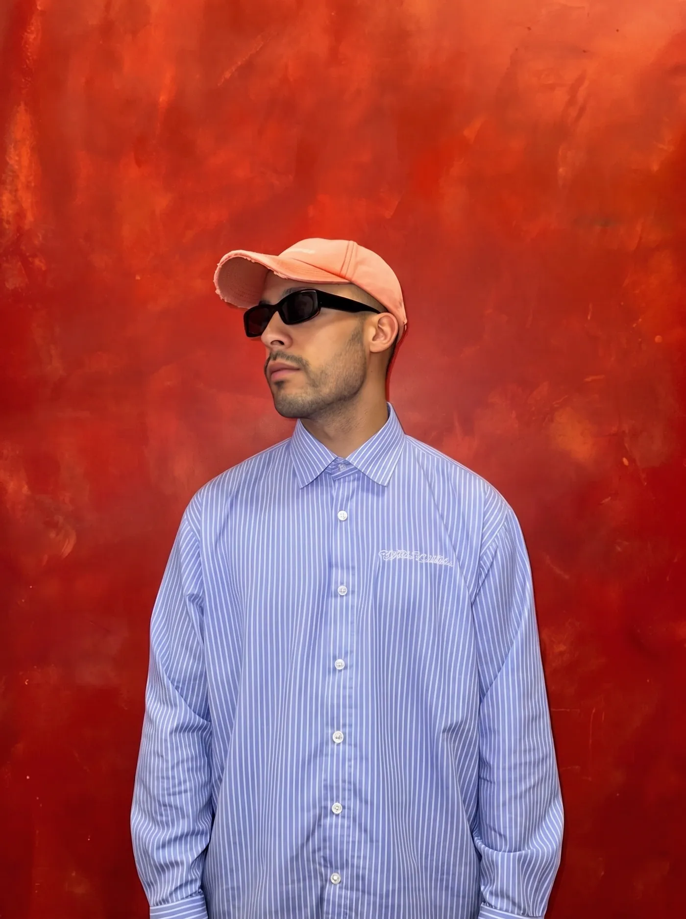 Side portrait of BDJ against the red wall